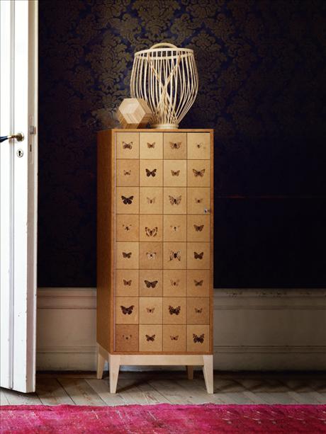blonde wood cabinet with butterfly motifs