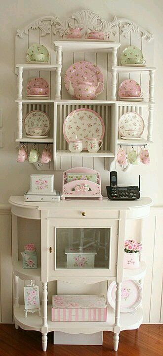 white cabinet with pink and green vintage items