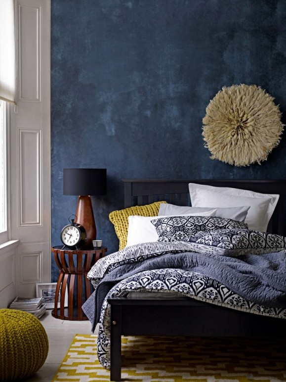deep blue accent wall in modern eclectic bedroom