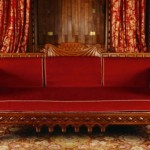 red neo-Norman style oak settee