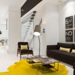 yellow rug in black and white living room